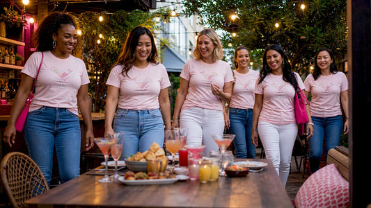 Group of women wearing matching shirts at happy hour