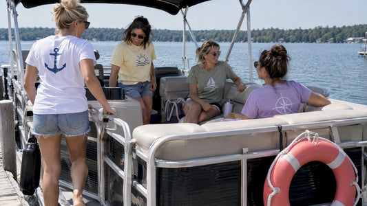 Friends wearing boat-day shirts aboard a pontoon